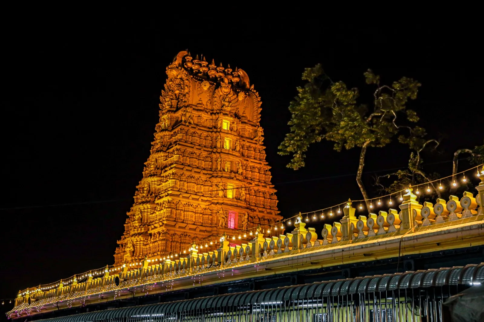 Golden gopuram of Sri Chamundeshwari Devi Temple glowing at night